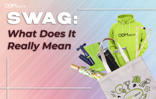 What does Swag Really Mean - A collection of ODM Group branded swag items including a hoodie, tumbler, notebook, and tote bag.