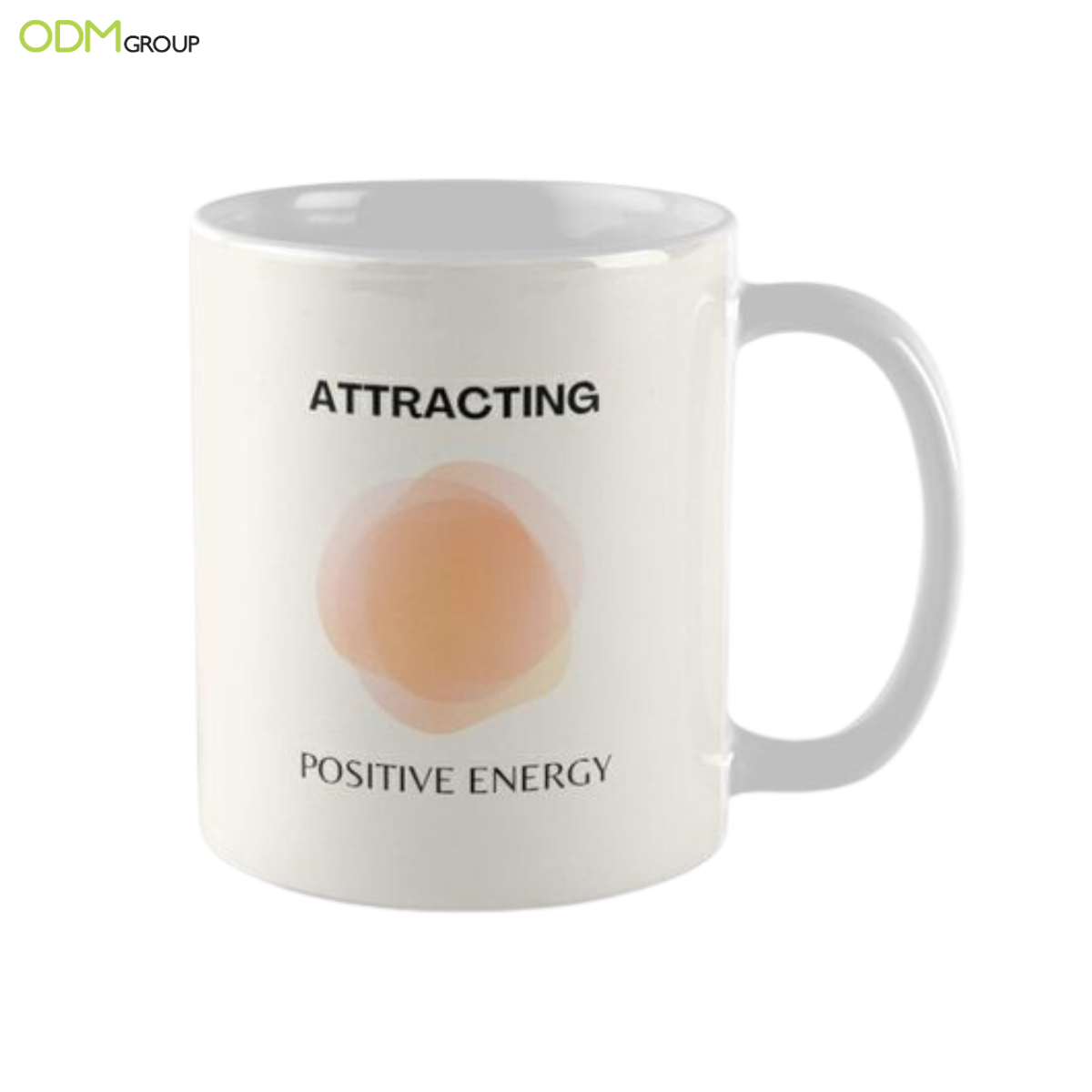 White mug with the words "Attracting Positive Energy" printed on it.