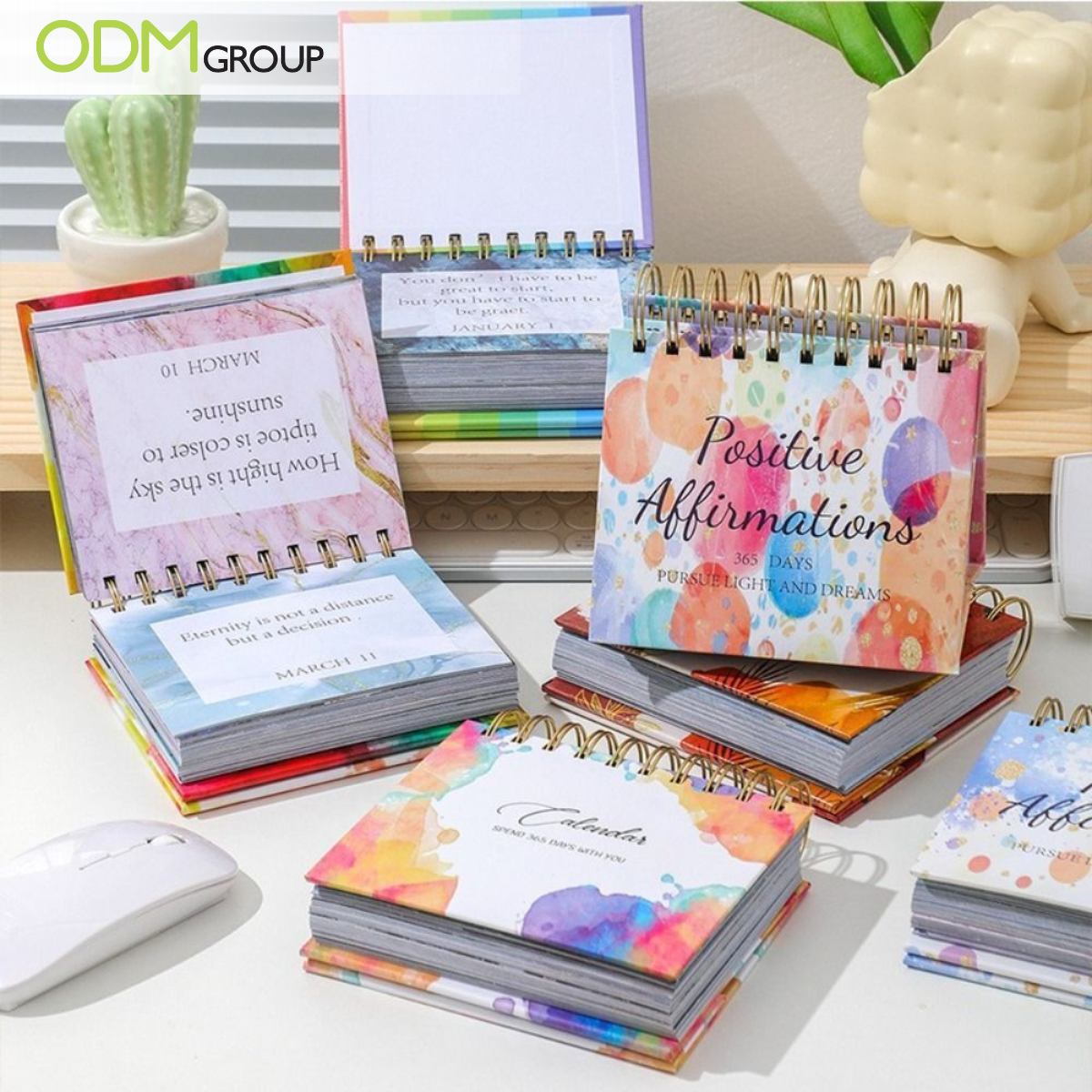 Desk calendars with colorful covers and pages filled with positive affirmations.