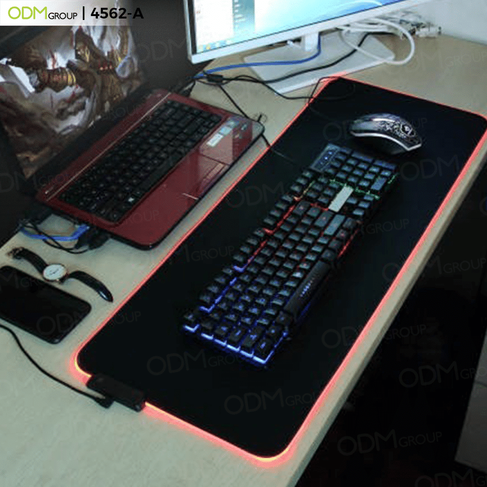 RGB gaming mouse pad with a keyboard and mouse on a desk.