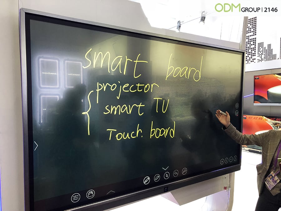A smart board display showing handwritten text.