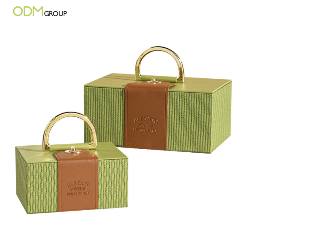 Elegant green reusable gift boxes with a handle, ideal for corporate holiday gifts.