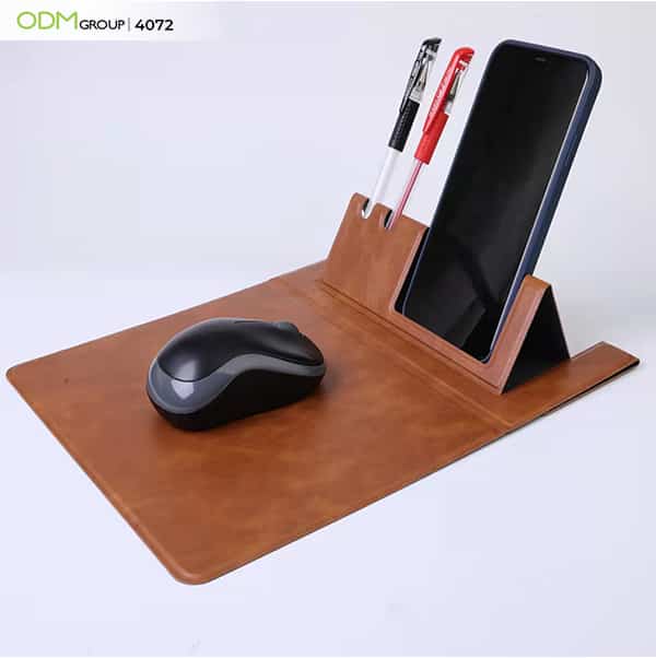 Leather mouse pad with integrated phone and pen holder.
